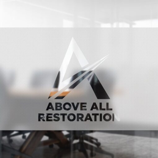 Logo cho Above All Restoration được thiết kế dưới dạng decal mờ cát trên kính mờ trong một văn phòng hiện đại, với chữ cái A được cách điệu cùng các đường nét động; ghế và bàn mờ ảo xuất hiện ở hậu cảnh.